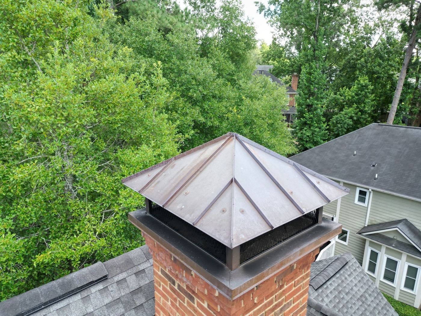 Aerial view of a chimney cap and roofline