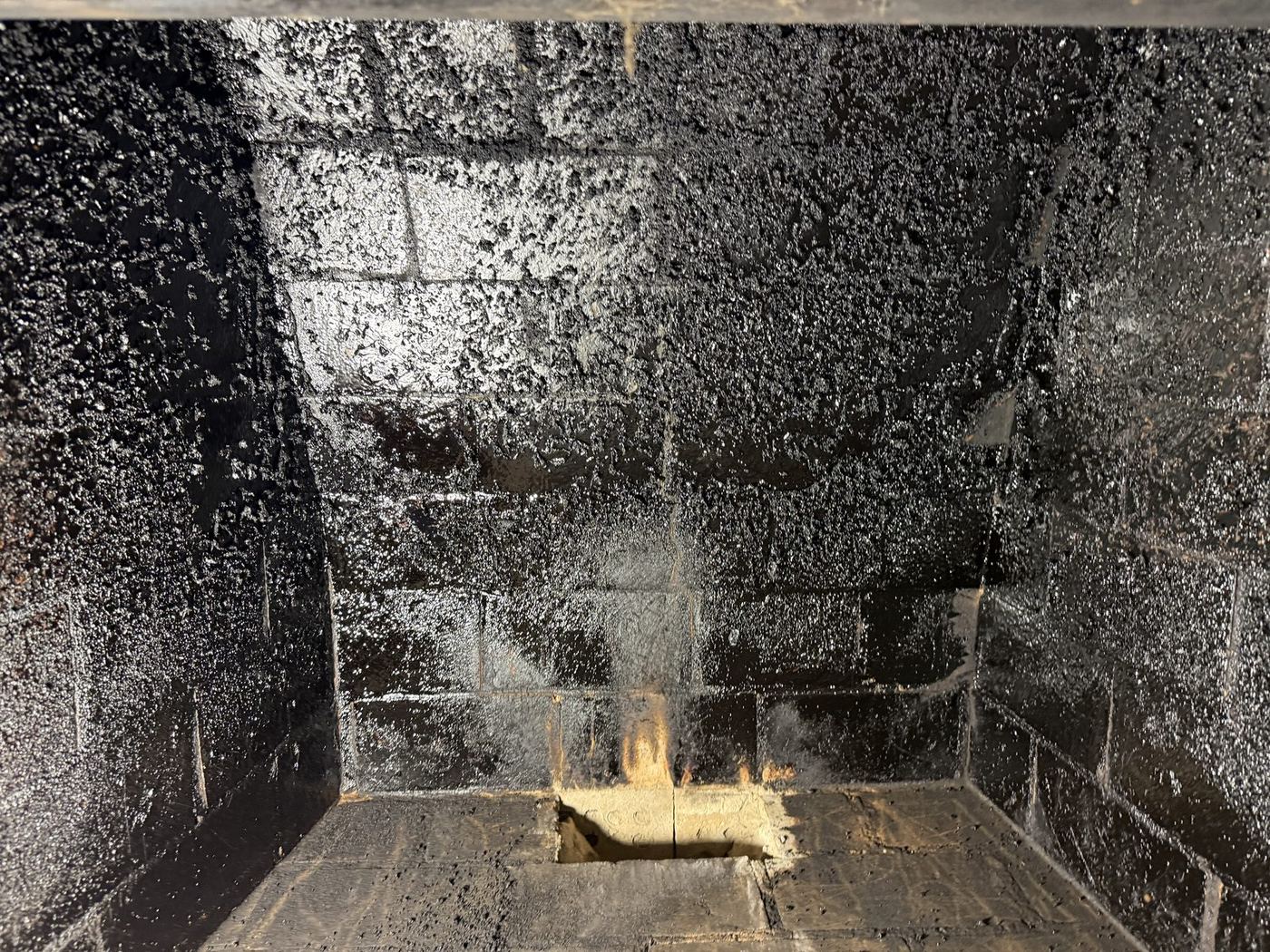 Glazed, tar-like creosote coating the inside of a firebox