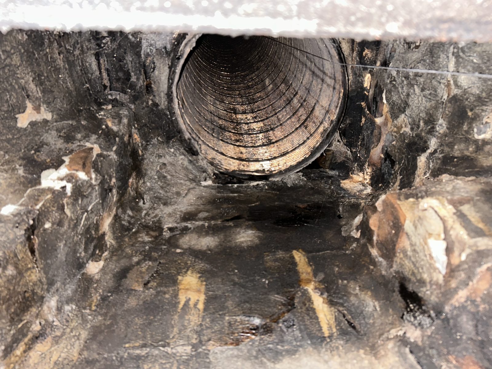 A cleaned masonry flue with a stainless steel liner visible