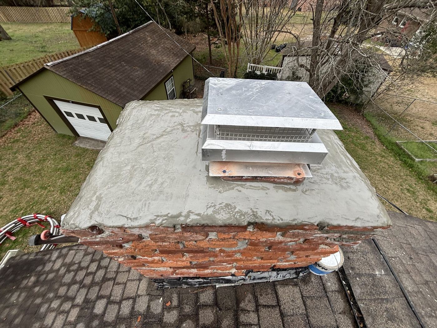 Freshly poured concrete chimney crown with a new cap