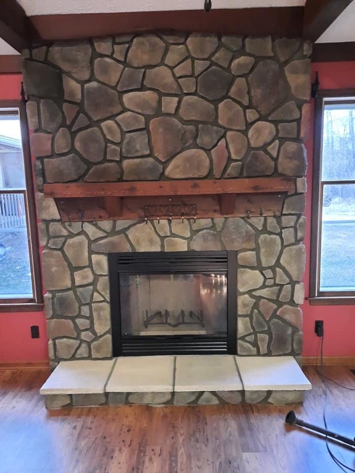 Fireplace refaced in natural stone with a new mantel