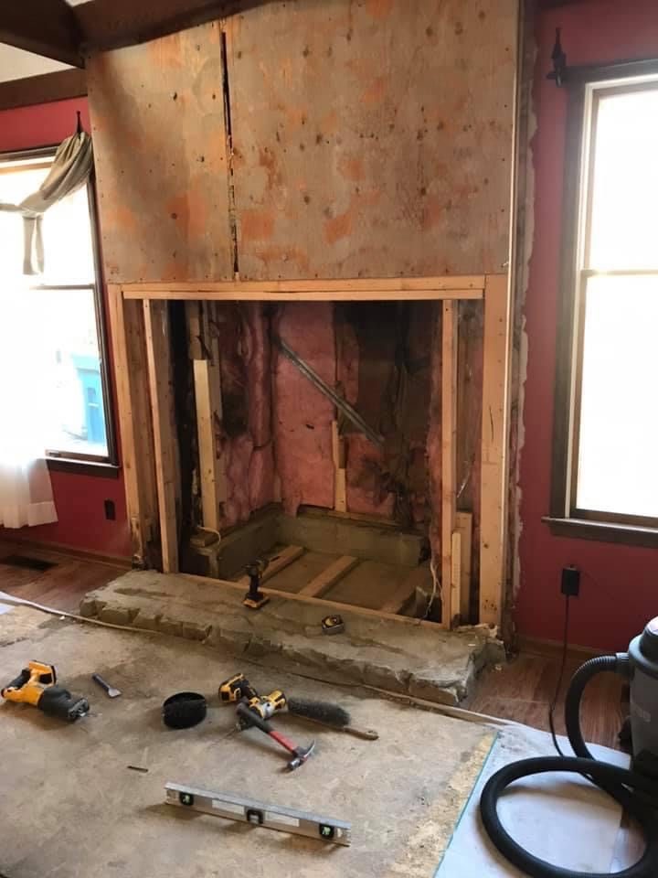 Fireplace stripped to the framing before refacing