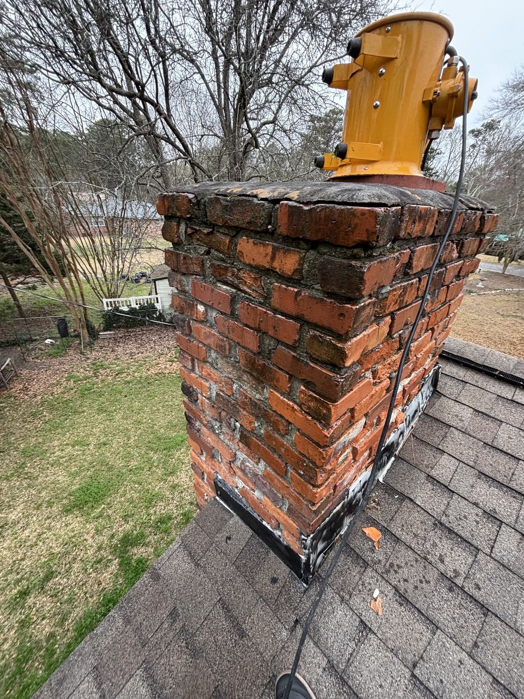 Stained brick chimney before soft washing