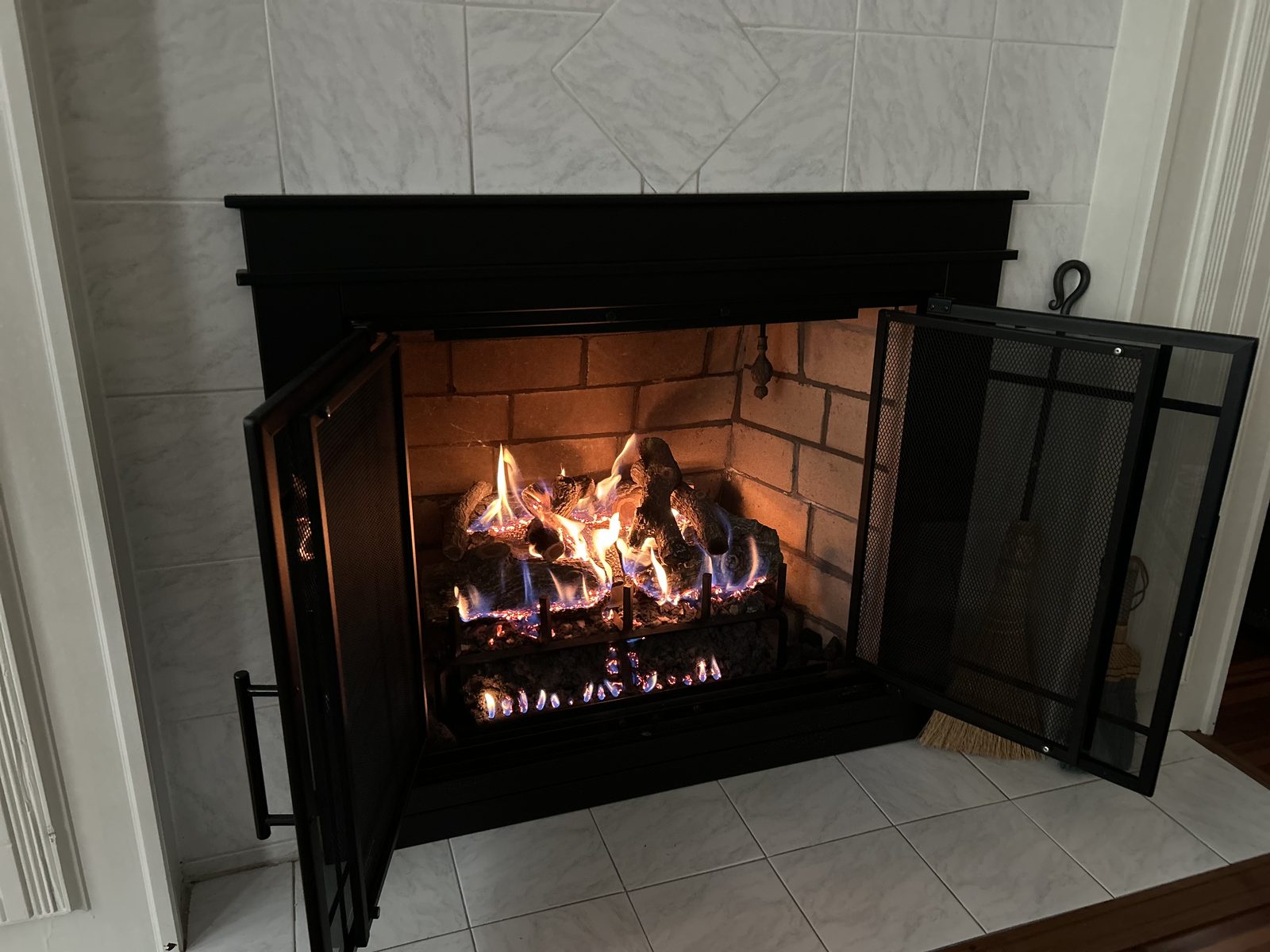 Open wood-burning fireplace with a new mesh screen